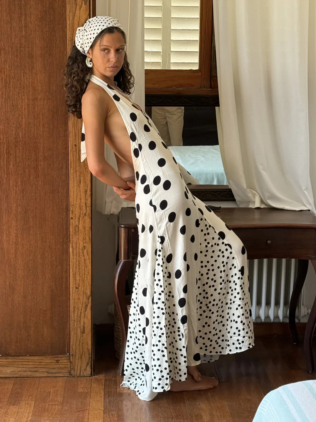 The Maria Dress offers a refined summer silhouette with its sleeveless halter design and delicate dot print. Featuring a lace-up back that creates an elegant backless effect, this maxi dress balances allure with comfort. Lightweight, flowing fabric ensures ease of movement, making it an ideal choice for warm evenings or vacation settings. Its thoughtful construction combines style and practicality, guaranteeing a standout presence in any occasion.