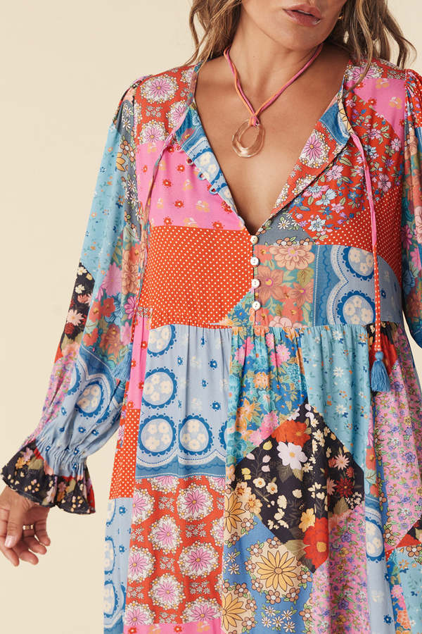 The Cha Cha Boho Midi Dress by Spell combines breathable, lightweight fabric with a refined design for ultimate comfort in warm weather. Its pull-on style and partial button front simplify dressing, while the tasseled tie neckline and cinched ruffled cuffs create a subtle, elegant bohemian aesthetic. This dress is an expert choice for those prioritizing both comfort and sophisticated style in their wardrobe.
