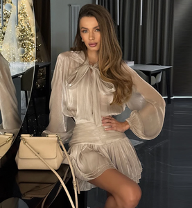 Elevate your wardrobe with the Melrose Shirt Dress, a refined dress featuring a backless blouse with a matching mini skirt. The blouse highlights a V-neckline and long lantern sleeves, adding a delicate yet striking touch. The accompanying A-line skirt offers a flattering silhouette, perfect for both day and evening occasions. This ensemble blends modern elegance with timeless charm, making it a sophisticated choice for confident women.