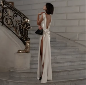 Indulge in luxury with the Darling Gown by DATT. Made from sumptuous silk, this gown exudes elegance. The back split adds a touch of allure while the intricate 3D rose embellishment elevates the design to a work of art. Perfect for those seeking a sophisticated and exclusive piece for their wardrobe.