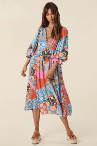 The Cha Cha Boho Midi Dress by Spell combines breathable, lightweight fabric with a refined design for ultimate comfort in warm weather. Its pull-on style and partial button front simplify dressing, while the tasseled tie neckline and cinched ruffled cuffs create a subtle, elegant bohemian aesthetic. This dress is an expert choice for those prioritizing both comfort and sophisticated style in their wardrobe.