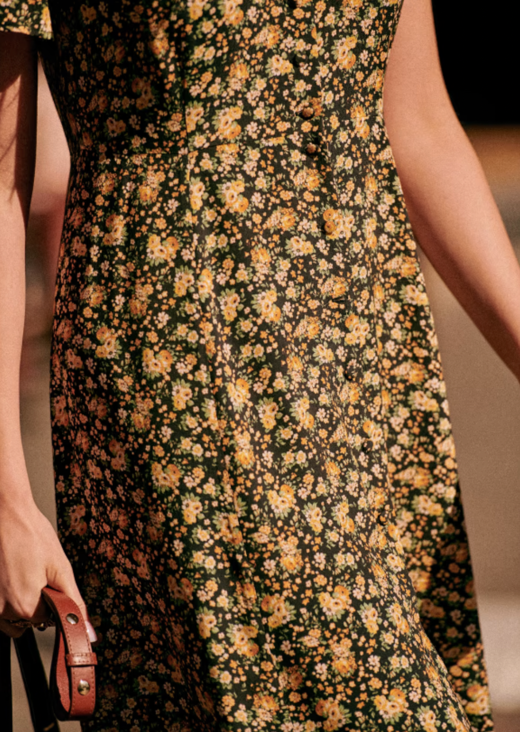 The Vivienne Dress by Sezane offers a graceful midi length silhouette with elegant short sleeves and a refined V neckline. Its button placket features covered buttons, adding a subtle yet polished touch. Fully lined for comfort and quality, this dress embodies sophisticated charm ideal for both formal and special occasions.