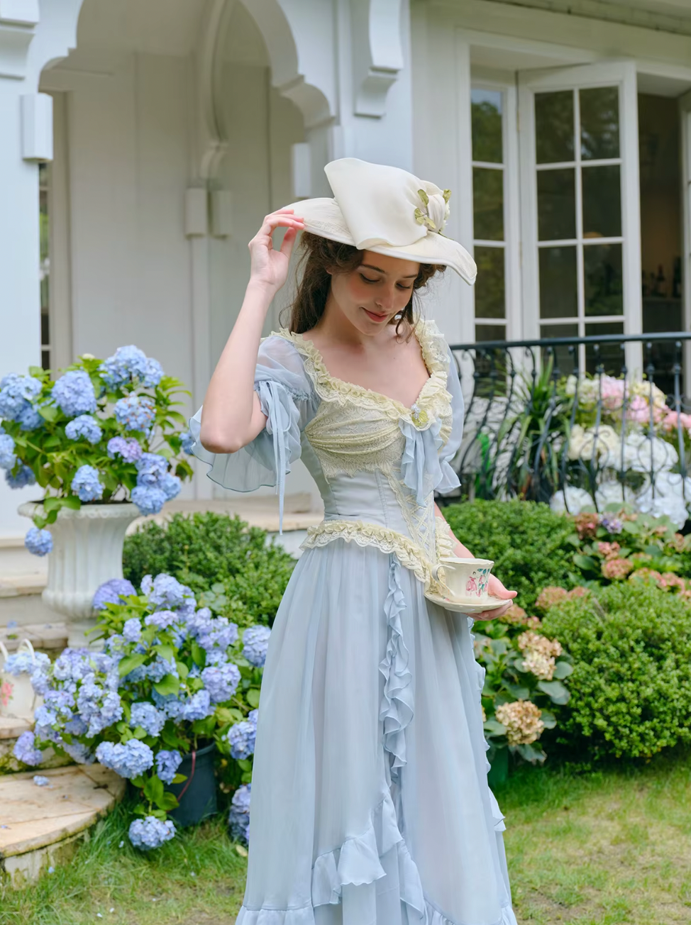 Introducing the Elora Dress - a vintage-inspired, slimming maxi dress in a sophisticated fishbone blue. With delicate lace accents and a seductive V-neck, this dress is perfect for summer parties and birthdays. Channel elegance and sexiness with every step in this exclusive piece.