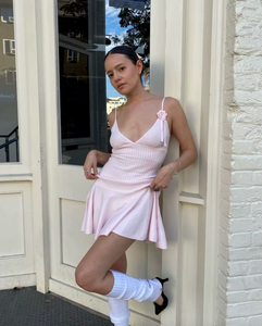 Introducing the Houston Knit Dress by Frankies Bikinis, the perfect dress for your casual outfit. Made from cloud knit fabric, in a beautiful Rose Quartz color. Features include adjustable shoulder straps and a custom knit rose & ribbon detail. Stay warm and stylish with the coziest dress of the season.