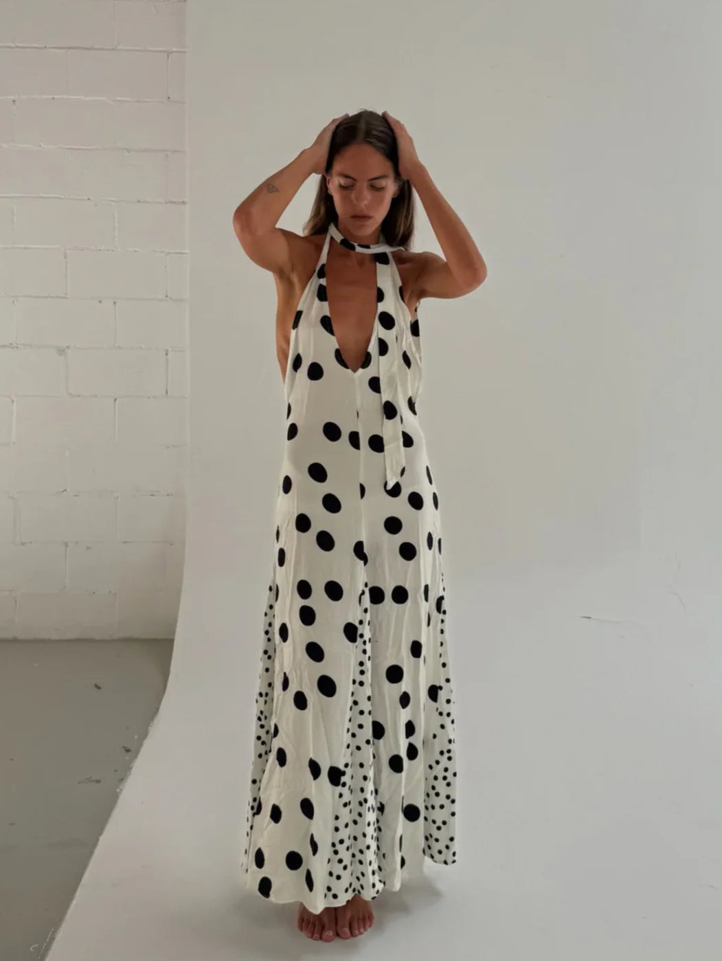The Maria Dress offers a refined summer silhouette with its sleeveless halter design and delicate dot print. Featuring a lace-up back that creates an elegant backless effect, this maxi dress balances allure with comfort. Lightweight, flowing fabric ensures ease of movement, making it an ideal choice for warm evenings or vacation settings. Its thoughtful construction combines style and practicality, guaranteeing a standout presence in any occasion.