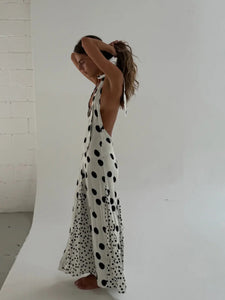 The Maria Dress offers a refined summer silhouette with its sleeveless halter design and delicate dot print. Featuring a lace-up back that creates an elegant backless effect, this maxi dress balances allure with comfort. Lightweight, flowing fabric ensures ease of movement, making it an ideal choice for warm evenings or vacation settings. Its thoughtful construction combines style and practicality, guaranteeing a standout presence in any occasion.