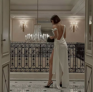 Indulge in luxury with the Darling Gown by DATT. Made from sumptuous silk, this gown exudes elegance. The back split adds a touch of allure while the intricate 3D rose embellishment elevates the design to a work of art. Perfect for those seeking a sophisticated and exclusive piece for their wardrobe.