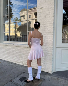 Introducing the Houston Knit Dress by Frankies Bikinis, the perfect dress for your casual outfit. Made from cloud knit fabric, in a beautiful Rose Quartz color. Features include adjustable shoulder straps and a custom knit rose & ribbon detail. Stay warm and stylish with the coziest dress of the season.