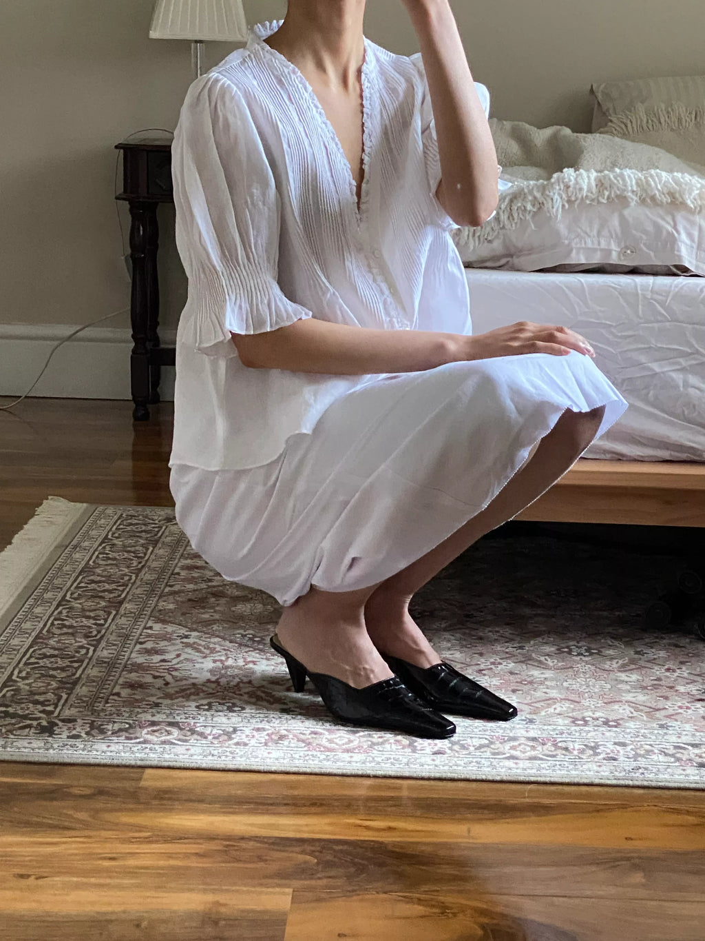 The Karlie Top by Doen combines lightweight ramie fabric with carefully designed details to create a refined, vintage-inspired piece. Its plunging V-neckline with soft ruffles and precise pintuck accents evoke Edwardian elegance. A starburst button line adds subtle sophistication, while short puffed sleeves introduce a modern, playful touch. Whether worn loose or tucked into high-waisted jeans, this top elevates your wardrobe with timeless style and effortless grace.