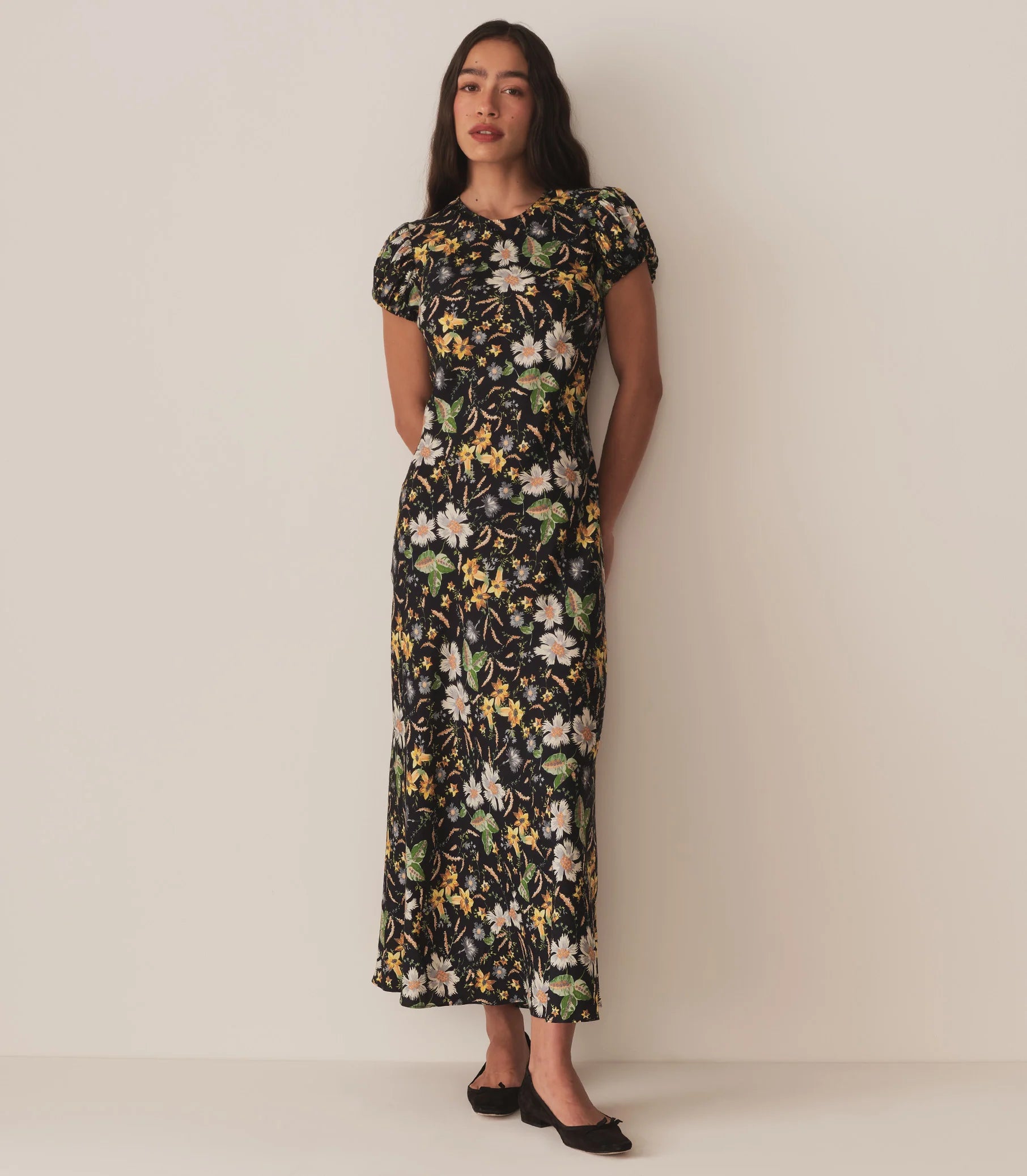 Crafted from a drapey silk-viscose twill, the Merla Dress by Doen in Sweet Anemone boasts an elegant bias cut that flatters the silhouette. Inspired by Art Deco motifs, this dress features a refined high neck and delicate short puffed sleeves, blending timeless style with modern sophistication. Perfect for occasions that call for understated glamour.