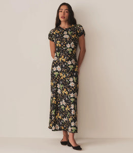 Crafted from a drapey silk-viscose twill, the Merla Dress by Doen in Sweet Anemone boasts an elegant bias cut that flatters the silhouette. Inspired by Art Deco motifs, this dress features a refined high neck and delicate short puffed sleeves, blending timeless style with modern sophistication. Perfect for occasions that call for understated glamour.