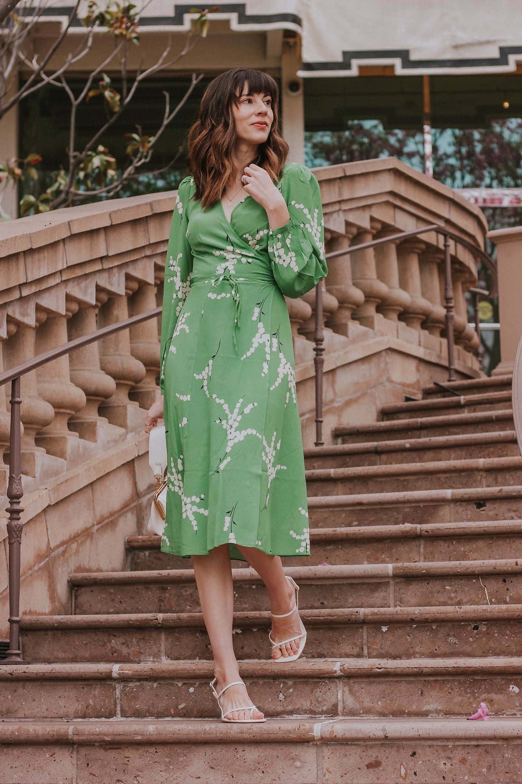 Show off your playful side in the Violette Midi Dress! This stunning lightweight silk dress features a white floral print on a vibrant green background. With 3/4 length sleeves and a comfortable wrap style, you can adjust the waist with the string tie closure. Embrace your love for summer in this unique and stylish dress!