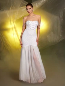 Indulge in ultimate luxury with the Colette Gown. This strapless gown features a stunning contrast of delicate white sequins and mesh beading, exuding effortless elegance and sensuality. Perfect for the discerning bride, this wholesale gown is a must-have for any bridal collection.