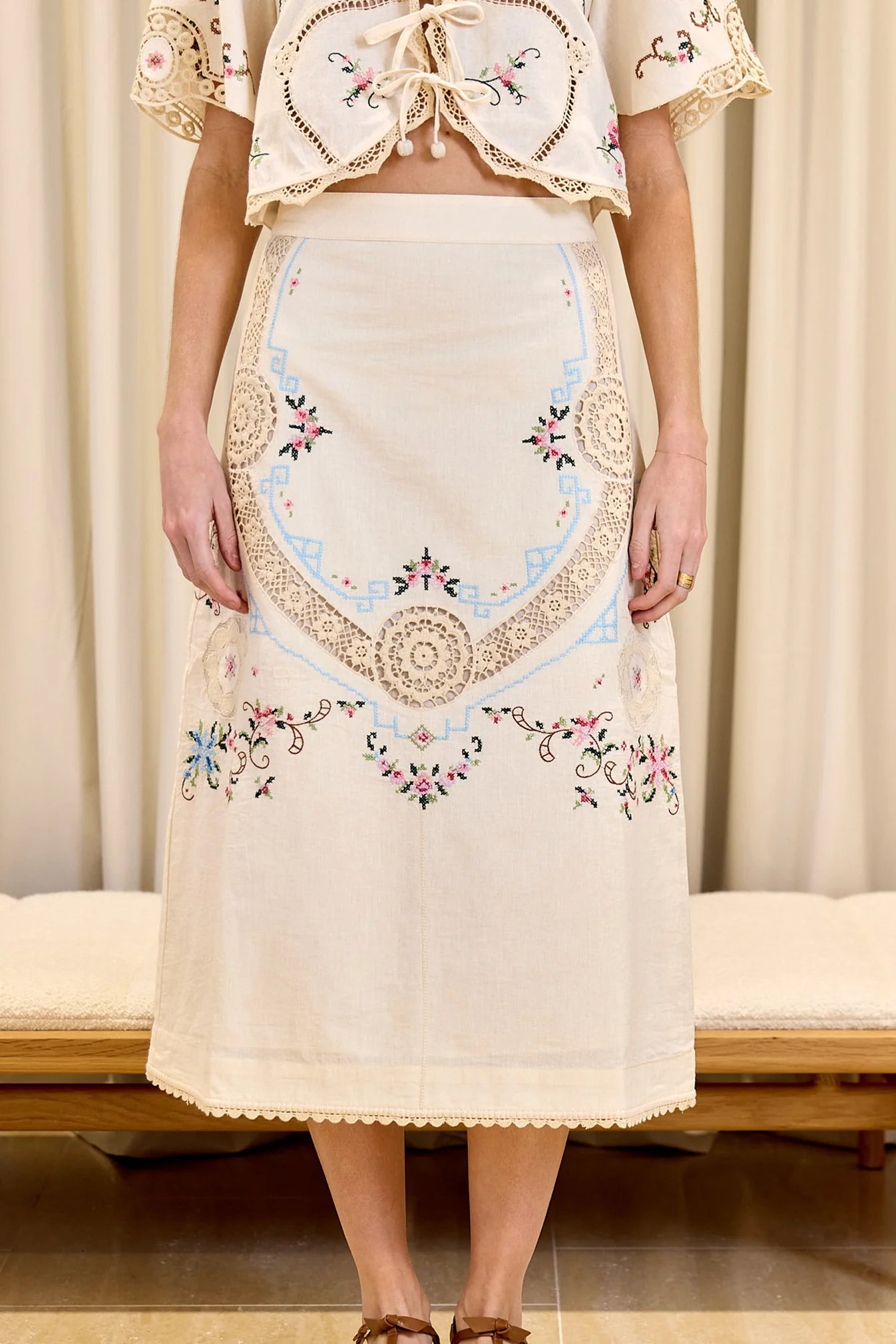 Indulge your senses in the Edwina Embroidery Skirt by SEA. With its intricate cross stitch embroidery and crochet trim detailing, this skirt exudes sophistication and luxury. Made with a blend of cotton and linen, and featuring a slim fit design, it is both stylish and comfortable. Complete the look with the invisible back zipper and a 100% cotton lining for a flawless finish.