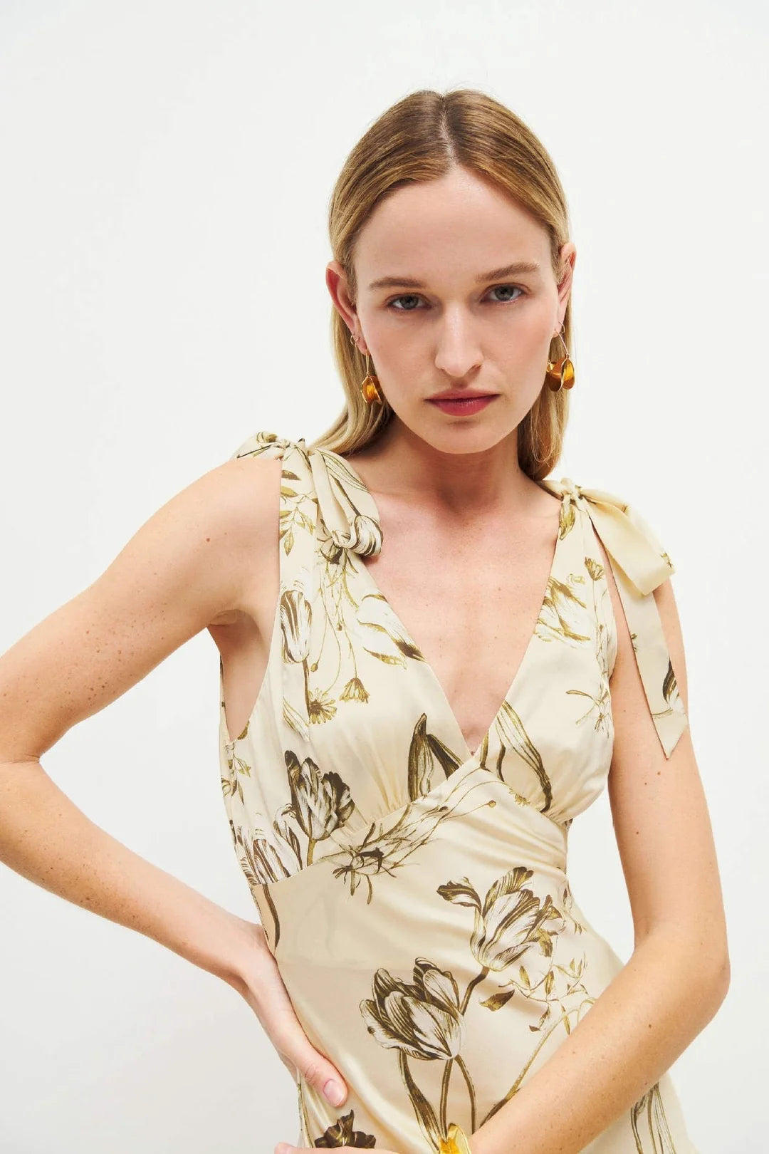 The Pernille Silk Dress exudes understated elegance with its delicate tie straps and flattering v-neck design. Crafted from lightweight silk charmeuse, it offers a graceful drape and subtle sheen. The Ivory colorway features a more substantial, higher-quality silk, lending a richer feel and justifying its exclusive price. This refined piece promises timeless sophistication for those who appreciate exquisite craftsmanship and luxurious fabric.