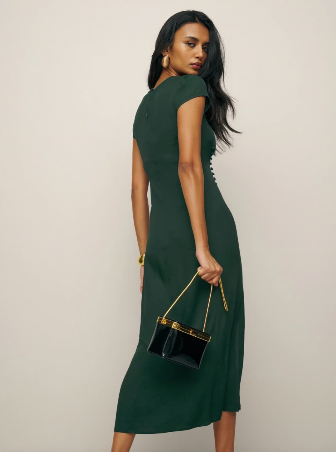 Experience refined elegance with the Frasier Dress by Reformation, thoughtfully made in Los Angeles. This sustainable midi dress features a crew neckline, cap sleeves, and an off-center button detail that enhances its sleek, slim silhouette. The high slit adds a subtle yet sophisticated edge, perfectly balancing modern design with eco-conscious craftsmanship. Ideal for those who prioritize both style and sustainability, this dress offers a polished look while supporting responsible fashion practices.