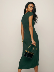 Experience refined elegance with the Frasier Dress by Reformation, thoughtfully made in Los Angeles. This sustainable midi dress features a crew neckline, cap sleeves, and an off-center button detail that enhances its sleek, slim silhouette. The high slit adds a subtle yet sophisticated edge, perfectly balancing modern design with eco-conscious craftsmanship. Ideal for those who prioritize both style and sustainability, this dress offers a polished look while supporting responsible fashion practices.