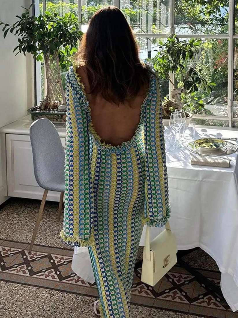 The Isla Maxi Dress is the perfect addition to your summer wardrobe. Crafted with a crochet knit and a stylish open back, this dress offers a fitted silhouette and bell sleeves for a trendy look. Ideal for beach vacations, it's a must-have for any fashion-forward woman.