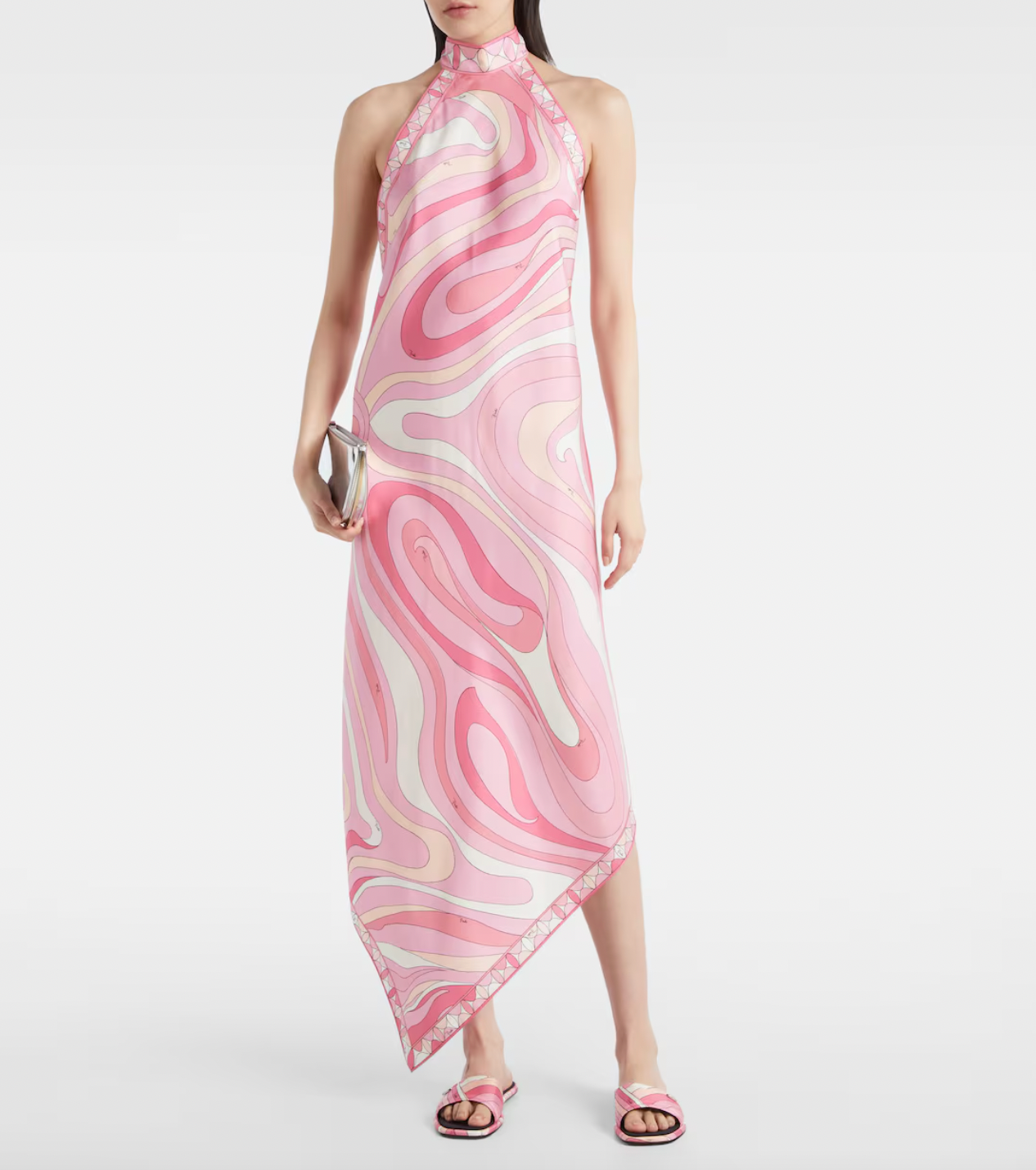 Embodying Pucci’s signature psychedelic swirling Marmo print, this silk maxi dress showcases expert craftsmanship and distinctive design. The asymmetric hem adds modern movement, while the high neckline and low back ensure a sophisticated yet alluring silhouette. Perfect for those seeking timeless elegance combined with bold, recognizable flair.