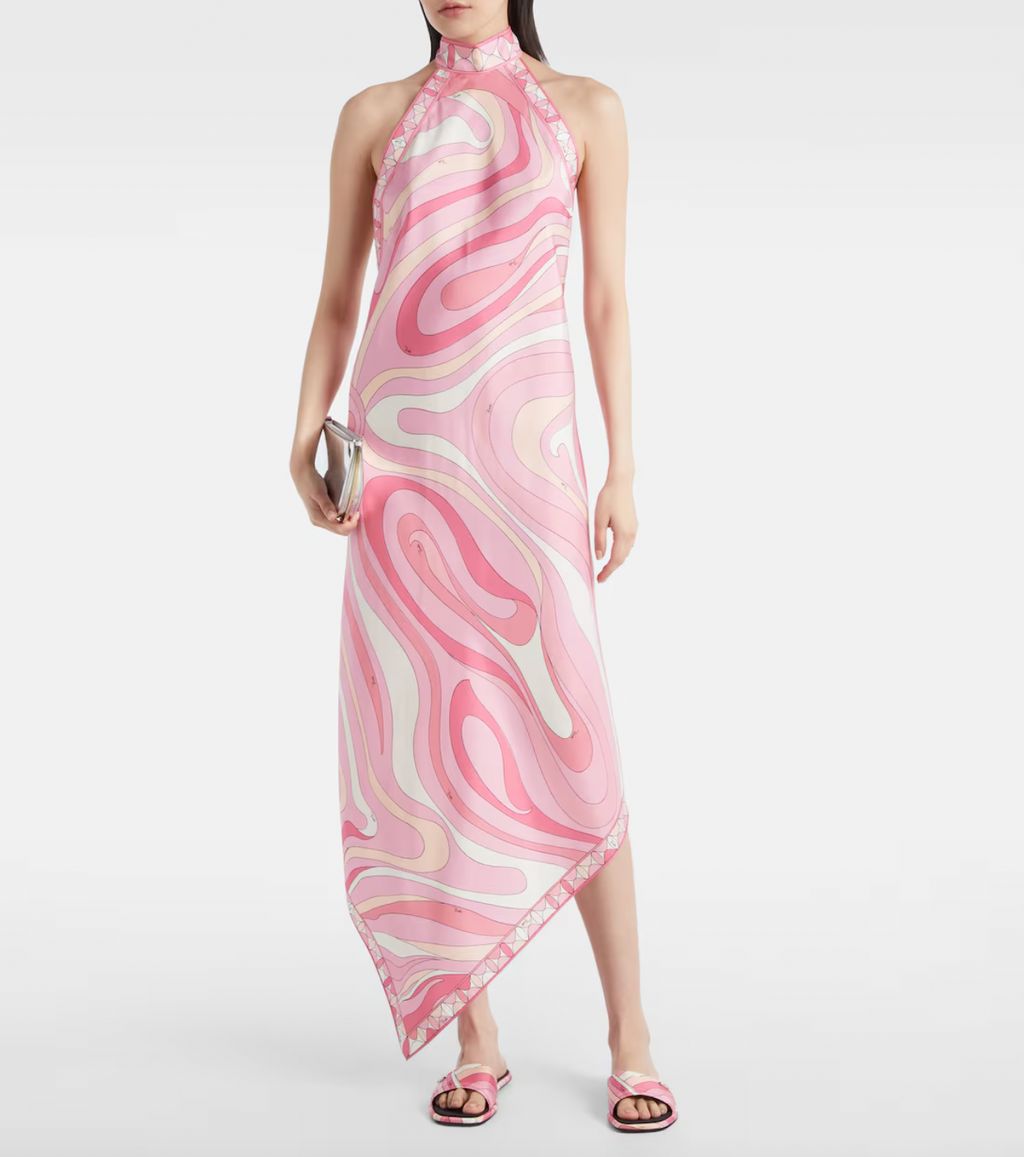 Embodying Pucci’s signature psychedelic swirling Marmo print, this silk maxi dress showcases expert craftsmanship and distinctive design. The asymmetric hem adds modern movement, while the high neckline and low back ensure a sophisticated yet alluring silhouette. Perfect for those seeking timeless elegance combined with bold, recognizable flair.