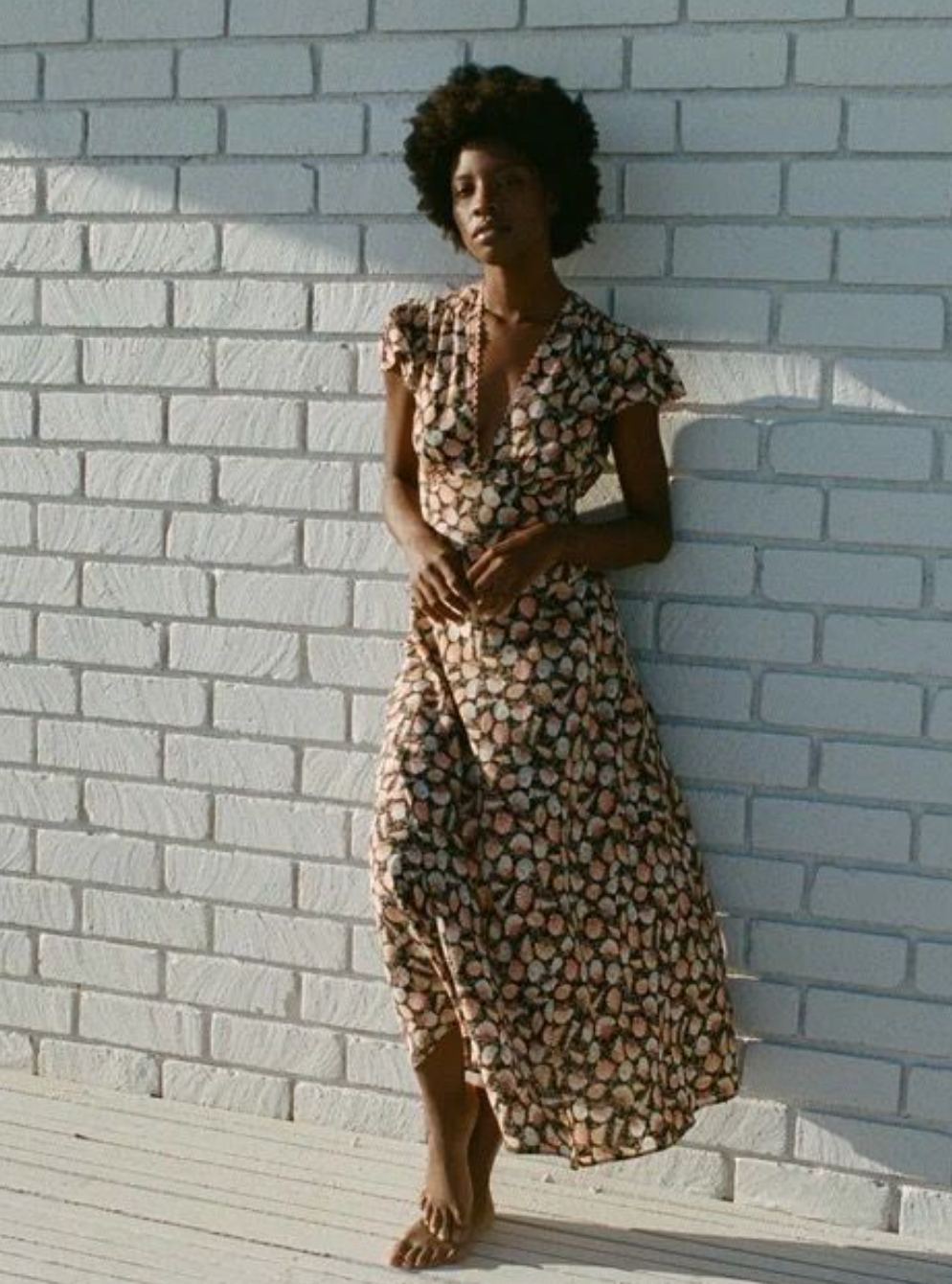 Crafted from luxurious sandwashed silk, this elegant maxi dress features a plunging V-neckline and delicate cap sleeves accented with contrasting scallop trim. The smocked shoulders and bust add refined texture, while the fitted bodice with an adjustable back tie creates a flattering silhouette. The bias-cut skirt gracefully skims the ankles, combining sophistication with effortless movement. Perfect for elevated occasions, the Adra Silk Maxi Dress exudes timeless charm.