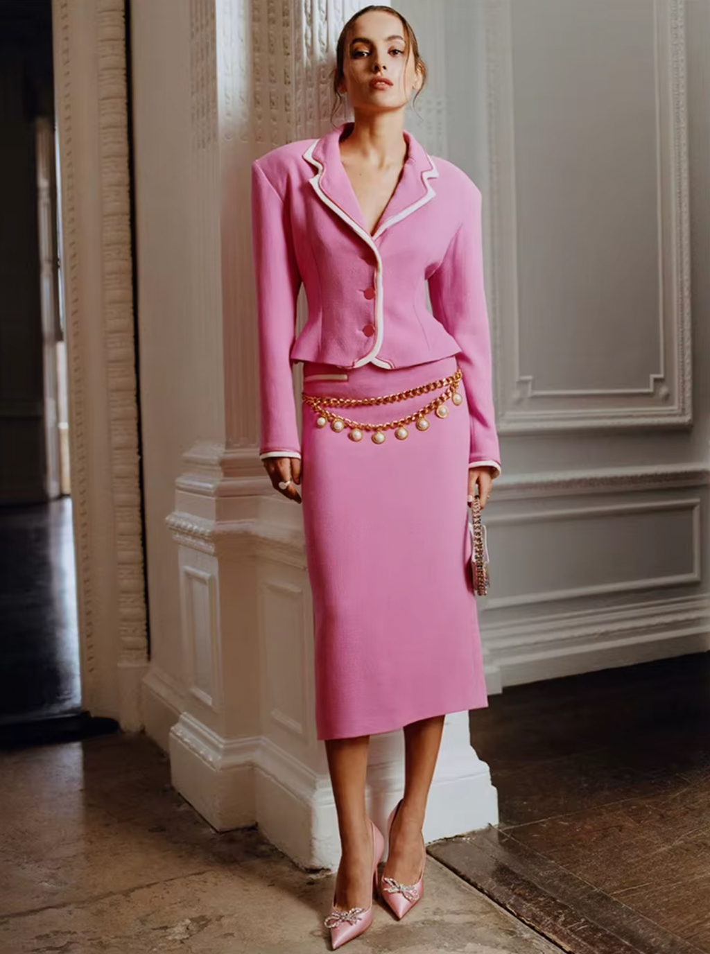 Unleash your inner femininity with the Cassidy Set. This luxurious two-piece ensemble features a pink jacket with contrasting details and a form-fitting knee-length skirt, accented with an elegant chain. Perfect for a night out, this set will make you stand out in any crowd.