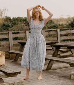 Crafted from 100% organic cotton poplin, the Quinn Dress in Dahlia Ditsy by DOEN offers refined comfort with a scoop neckline accented by an adjustable tie and an elegant keyhole detail, creating a graceful silhouette perfect for any occasion.