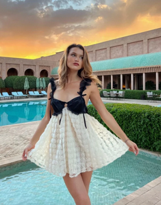 The Poppy Mini Dress from For Love & Lemons exudes luxury and sophistication with its 3D rose flock dot fabric and contrast satin cups. Underwire provides support while chiffon ruffled straps add a touch of femininity. The sheer skirt and keyhole back add allure, while the S-hook and invisible zip closures ensure a perfect fit. Fully lined for added comfort.