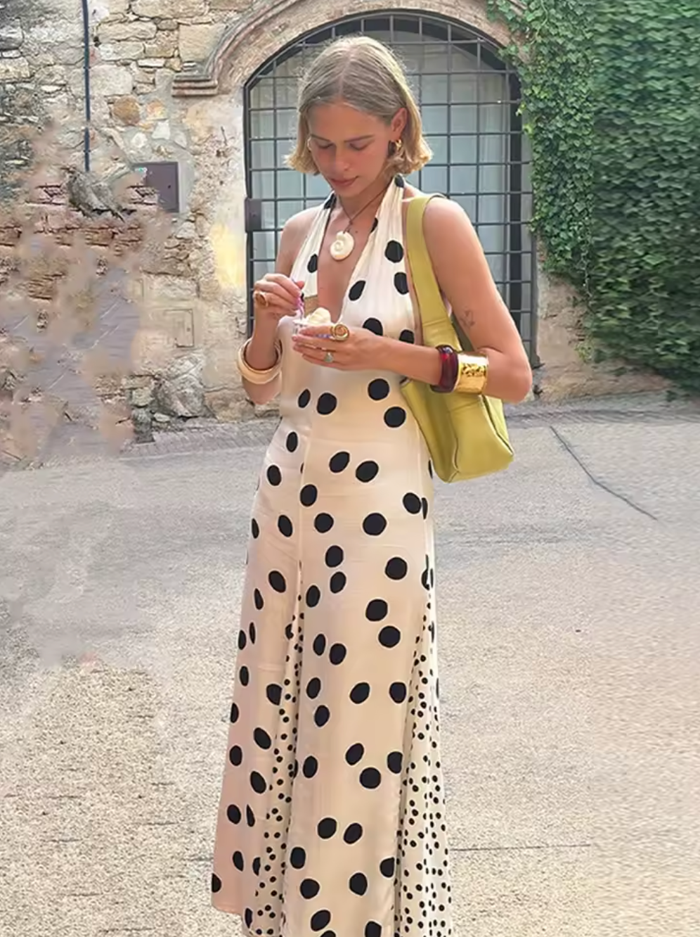 The Maria Dress offers a refined summer silhouette with its sleeveless halter design and delicate dot print. Featuring a lace-up back that creates an elegant backless effect, this maxi dress balances allure with comfort. Lightweight, flowing fabric ensures ease of movement, making it an ideal choice for warm evenings or vacation settings. Its thoughtful construction combines style and practicality, guaranteeing a standout presence in any occasion.