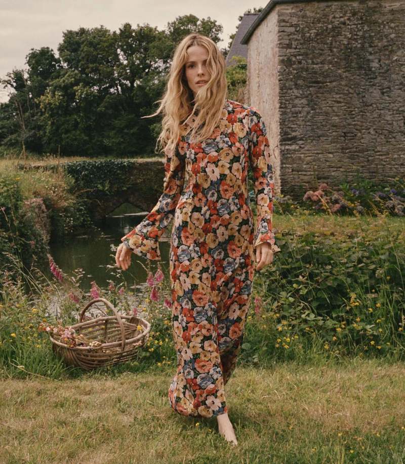 Crafted from washed silk crepe de chine, the Musetta Dress in Poppy Meadow by Doen combines elegance with refined tailoring. It features a sophisticated mock neck and dramatic flared sleeves finished with delicate ruffle trims at the cuffs. The fitted bodice, enhanced by an invisible side zipper, seamlessly flows into an ankle-grazing bias-cut skirt, ensuring a flattering silhouette and graceful movement. Ideal for those seeking timeless style with subtle, expert detailing.