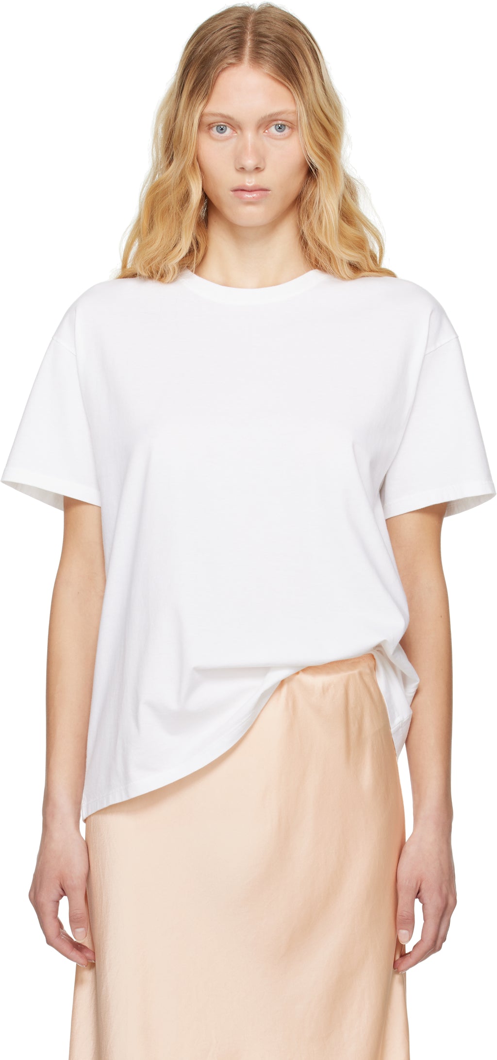 The White Nadina Oversized Short-Sleeve Top by The Row is expertly crafted from soft white cotton, balancing comfort with sophisticated design. Its classic crew neckline and short sleeves complement the clean, straight hem, while the oversized fit provides relaxed ease enhanced by subtle ribbed detailing for added texture and structure. This versatile tee offers a refined, effortless aesthetic, perfect for layering or standalone wear.
