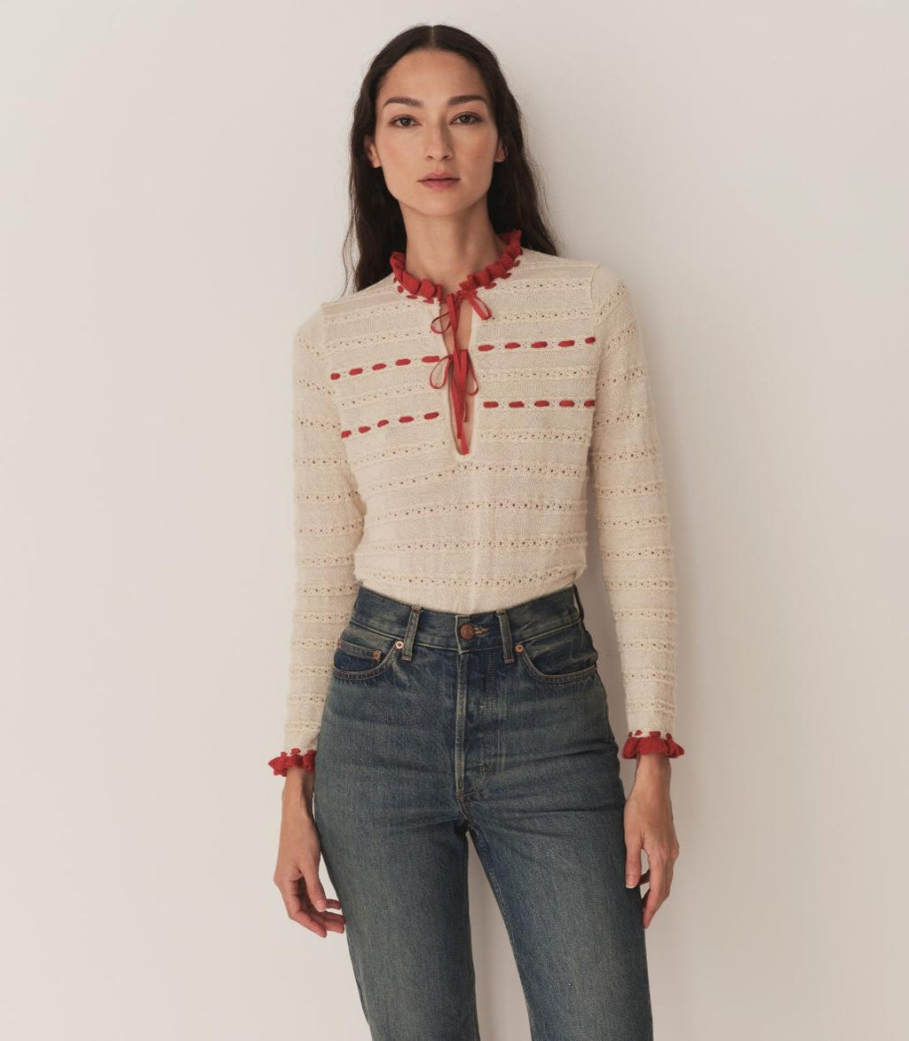 Inspired by 1940s knitwear, the Cordelie Top in Moonstone features a luxurious blend of 80% baby alpaca and 20% silk for exceptional softness and warmth. Lightweight yet insulating, this layerable piece offers delicate sophistication with silk grosgrain ribbons that tie elegantly at the neck. Crafted in Peru with sheer opaque fabric, it combines refined heritage style with modern comfort for versatile wear.