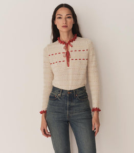 Inspired by 1940s knitwear, the Cordelie Top in Moonstone features a luxurious blend of 80% baby alpaca and 20% silk for exceptional softness and warmth. Lightweight yet insulating, this layerable piece offers delicate sophistication with silk grosgrain ribbons that tie elegantly at the neck. Crafted in Peru with sheer opaque fabric, it combines refined heritage style with modern comfort for versatile wear.