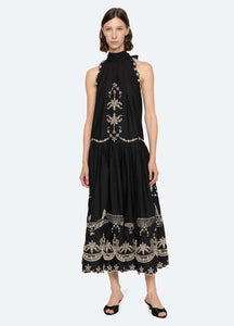 The Kingsley embroidered tank dress by SEA NY showcases intricate embroidery throughout its design, offering a refined and elegant appeal. It features a high neckline that adds a sophisticated touch, complemented by a delicate back bow tie for adjustable fit and added charm. The scalloped hemline enhances the dress's feminine silhouette, making it an exceptional choice for those seeking a polished yet distinctive look.