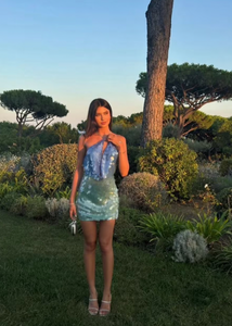 The Kiki Mini Dress dazzles with a molten sequin design that shifts in an ombré gradient from blue to green, capturing light with every movement. Its slinky silhouette is ideal for summer evenings, enhanced by a daring plunge back and an extreme cowl neckline that together create a strikingly sensual appeal. Perfect for making a bold statement at any night event.