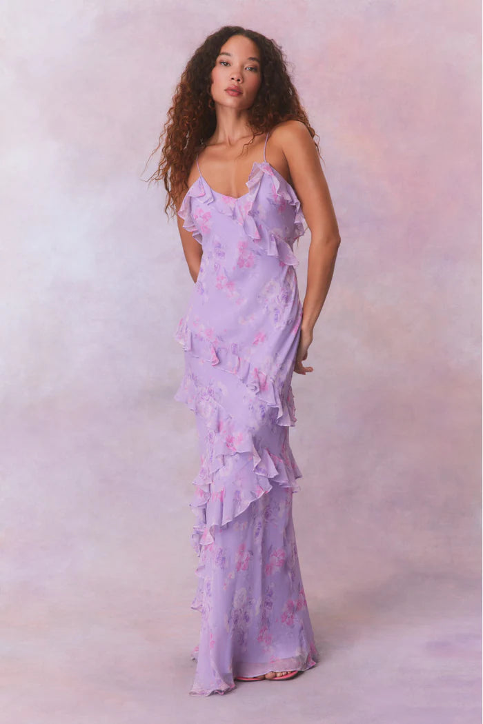 Designed with elegance and movement in mind, the Rialto Maxi Dress in Hibiscus captivates with its chiffon fabric and cascading asymmetrical ruffles that flow from neckline to hem. Its slightly fitted silhouette enhances your figure with subtle allure, while a discreet side seam zipper ensures a seamless fit. Perfect for dancing or any refined occasion, this dress combines comfort with sophisticated style effortlessly.