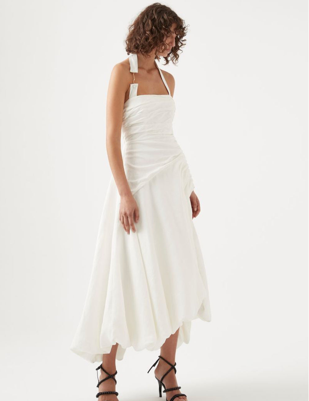 Elevate your elegance with the Mika Draped Split Maxi Dress in Ivory by Aje. Crafted from midweight ruched linen, this fully lined dress features a sophisticated asymmetrical hem that flows gracefully. The exposed back zipper adds a modern edge, while the gold-tone and faux pearl accents on the halterneck strap enhance its refined charm. Perfect for making a timeless statement at any upscale event.