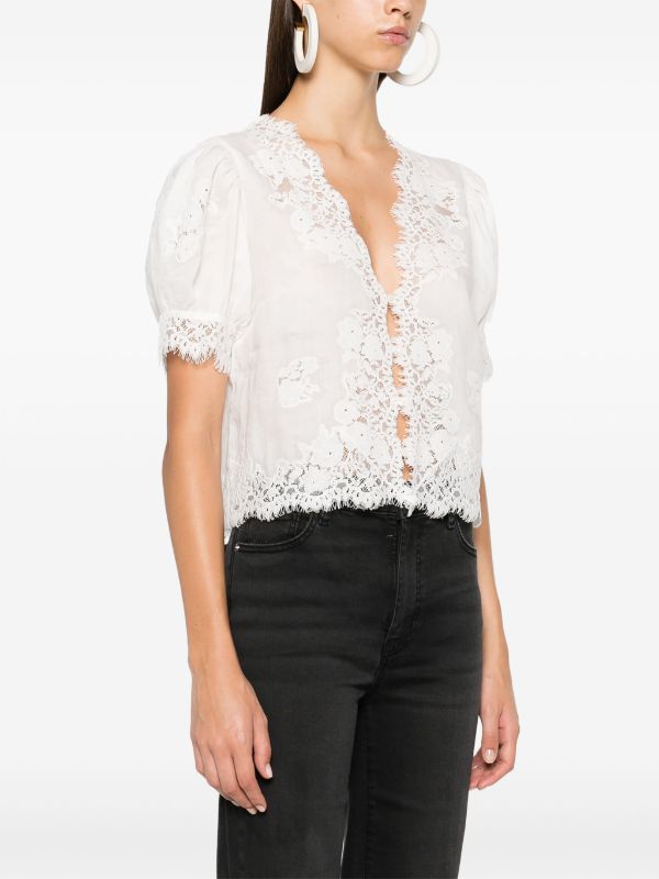 Introducing the luxurious Idella top by DOEN. Made from high-quality, soft ramie and delicate guipure lace, this top boasts a flattering V-neck and elegant scallop hem. Its front button fastening and short puff sleeves add a touch of sophistication to this white beauty. Upgrade your wardrobe with the Idella top.