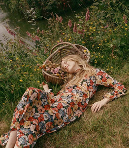 Crafted from washed silk crepe de chine, the Musetta Dress in Poppy Meadow by Doen combines elegance with refined tailoring. It features a sophisticated mock neck and dramatic flared sleeves finished with delicate ruffle trims at the cuffs. The fitted bodice, enhanced by an invisible side zipper, seamlessly flows into an ankle-grazing bias-cut skirt, ensuring a flattering silhouette and graceful movement. Ideal for those seeking timeless style with subtle, expert detailing.