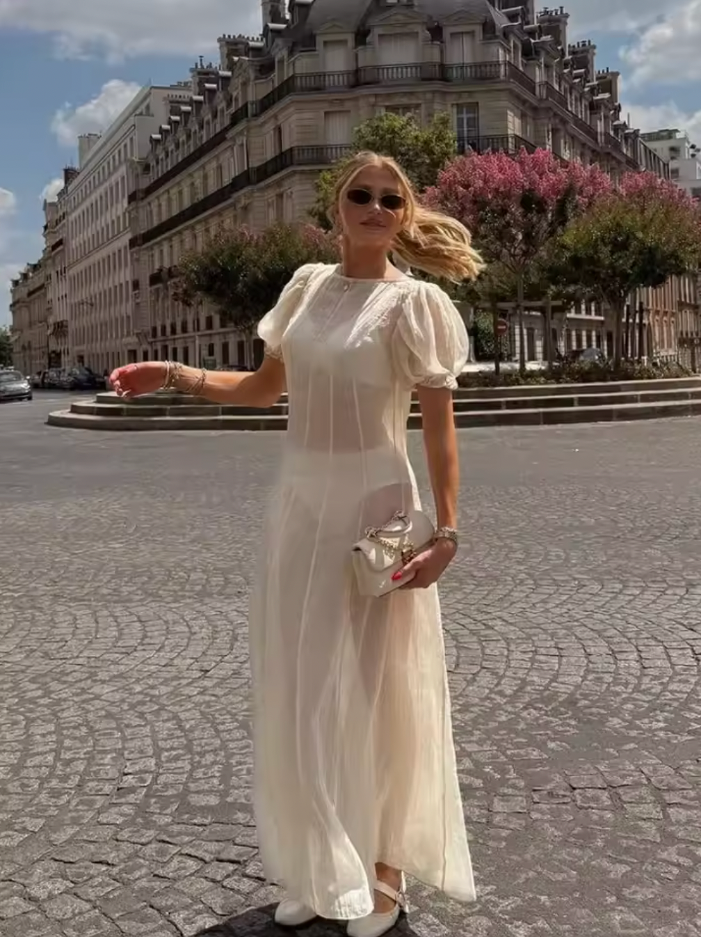 The Emory Dress features delicate chiffon fabric with elegant puff sleeves and elastic cuffs, creating a romantic silhouette. Its unlined, sheer design reveals undergarments, enhancing its ethereal appeal—please note undergarments are not included. A discreet back zip closure ensures a smooth fit, while hand wash care maintains the dress's lightweight texture and shape. Ideal for those seeking a sophisticated statement piece with a modern, airy feel.