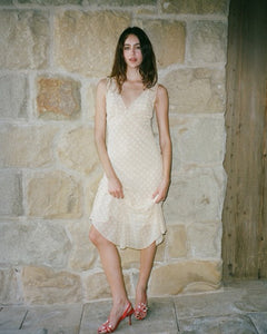 The Cleo Dress in Honey Spot by Realisation embodies effortless femininity with its light, floaty fabric and delicate sheer design. Featuring a flattering plunging V-neckline, sculpting panelled waist, and a fluted skirt that drapes gracefully, this dress is perfect for warm summer days and sultry evenings. The slightly shorter hemline adds a playful touch, while the removable underslip allows you to customize your look—opt for bold sheerness or a more refined silhouette. 