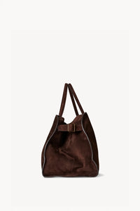 Gracefully structured top handle bag from The Row, crafted in soft calfskin suede with belted, gusseted side panels and a sleek interior.
