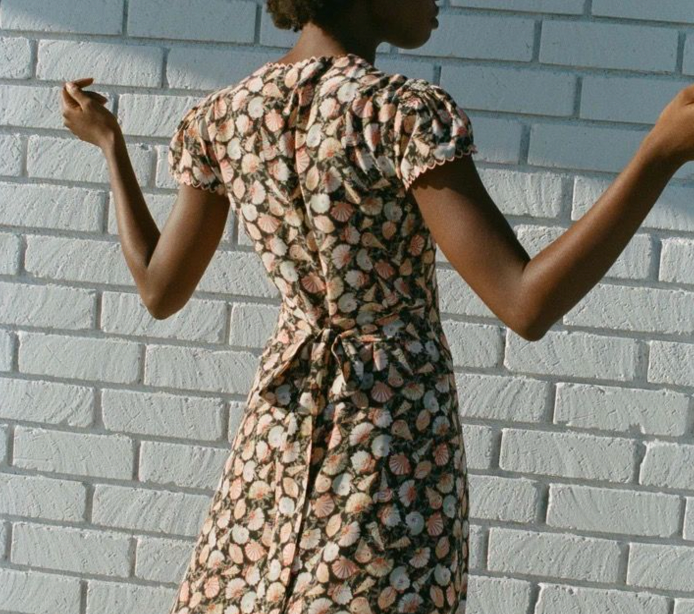 Crafted from luxurious sandwashed silk, this elegant maxi dress features a plunging V-neckline and delicate cap sleeves accented with contrasting scallop trim. The smocked shoulders and bust add refined texture, while the fitted bodice with an adjustable back tie creates a flattering silhouette. The bias-cut skirt gracefully skims the ankles, combining sophistication with effortless movement. Perfect for elevated occasions, the Adra Silk Maxi Dress exudes timeless charm.