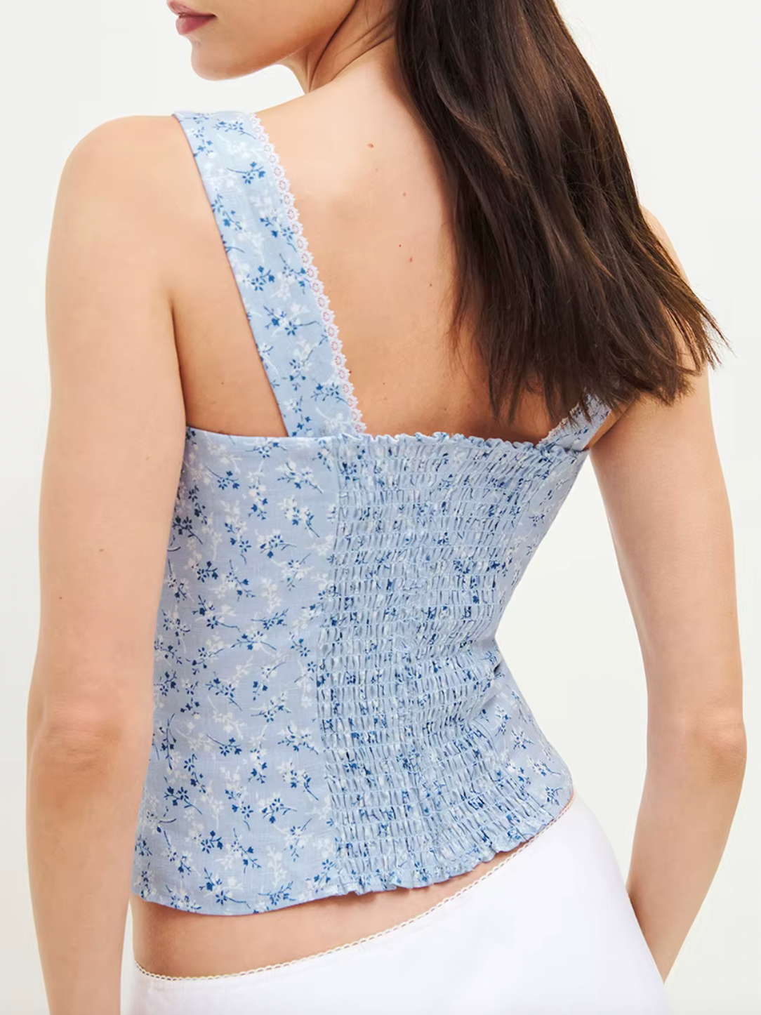Indulge in sustainable luxury with the Tagliatelle Linen Top by Reformation. This slim-fitting sleeveless top is expertly crafted from high-quality linen and adorned with delicate lace trims for a romantic touch. Elevate your wardrobe while making a positive impact on the environment.