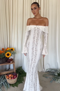 The Belle Maxi Dress offers a contemporary and classic design with a curve-creating silhouette. Made from stretch floral lace and featuring internal boning, it beautifully showcases your figure while providing elegant draping off the shoulder. The contrast lining adds an extra touch of sophistication.