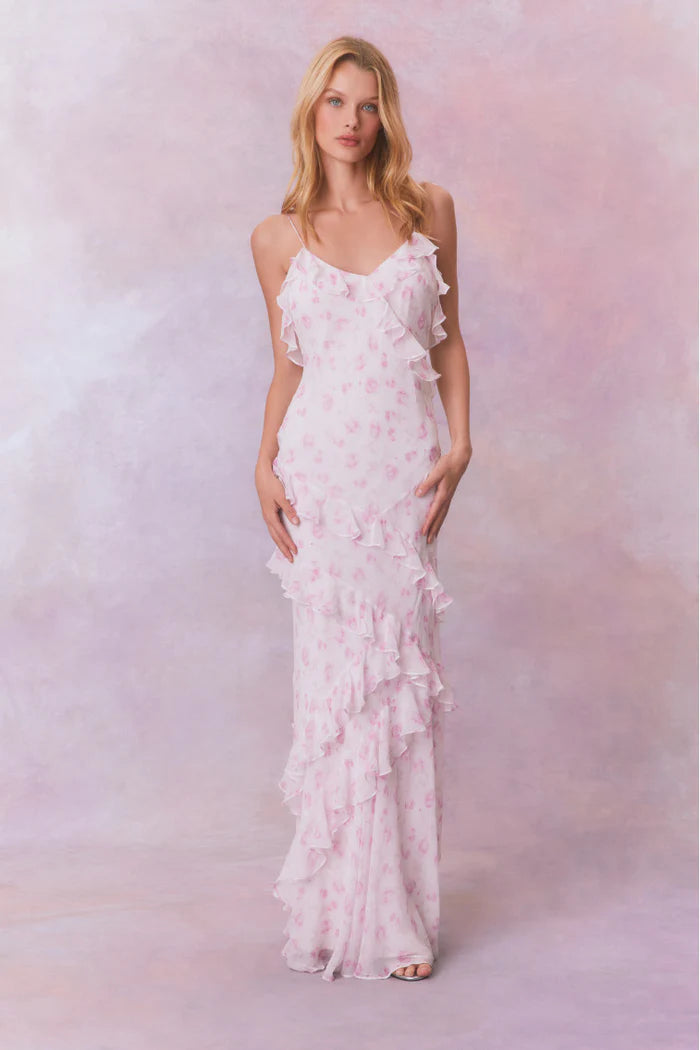 Designed with elegance and movement in mind, the Rialto Maxi Dress in Sterling Dust captivates with its chiffon fabric and cascading asymmetrical ruffles that flow from neckline to hem. Its slightly fitted silhouette enhances your figure with subtle allure, while a discreet side seam zipper ensures a seamless fit. Perfect for dancing or any refined occasion, this dress combines comfort with sophisticated style effortlessly.