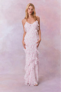 Designed with elegance and movement in mind, the Rialto Maxi Dress in Sterling Dust captivates with its chiffon fabric and cascading asymmetrical ruffles that flow from neckline to hem. Its slightly fitted silhouette enhances your figure with subtle allure, while a discreet side seam zipper ensures a seamless fit. Perfect for dancing or any refined occasion, this dress combines comfort with sophisticated style effortlessly.