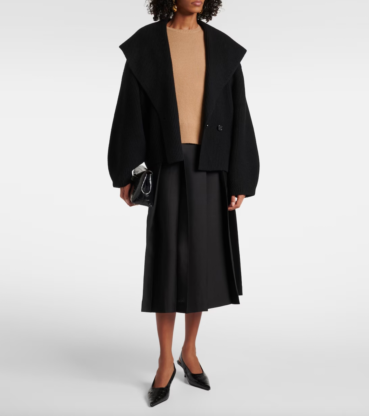 This Toteme wool-blend cardigan offers refined warmth and timeless style. Crafted from a premium wool blend, it provides softness and insulation perfect for layering in cooler weather. Its clean lines and subtle detailing ensure a versatile piece suitable for both casual and more polished looks, making it a valuable addition to any discerning wardrobe.