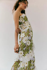 Experience effortless femininity and ethereal beauty in the Flora Maxi Dress. Crafted from delicate embroidered lace, this slim-fitting silhouette boasts an asymmetric neckline and cascading ruffles that add a touch of romance. The flared A-line hem and invisible zipper make for a flattering fit. Perfect for any special occasion!