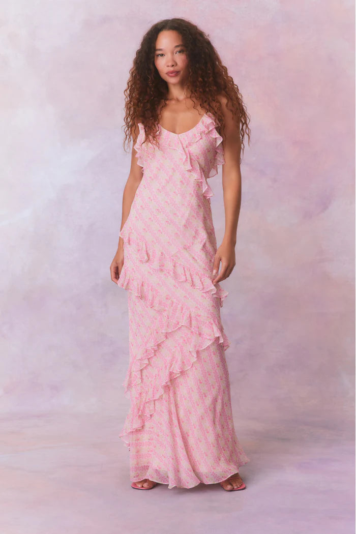 Designed with elegance and movement in mind, the Rialto Maxi Dress in Strawberry Macaroon captivates with its chiffon fabric and cascading asymmetrical ruffles that flow from neckline to hem. Its slightly fitted silhouette enhances your figure with subtle allure, while a discreet side seam zipper ensures a seamless fit. Perfect for dancing or any refined occasion, this dress combines comfort with sophisticated style effortlessly.